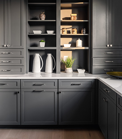A unique Butler's Pantry of dark grey cabinets and shelving, white q quartz countertops.