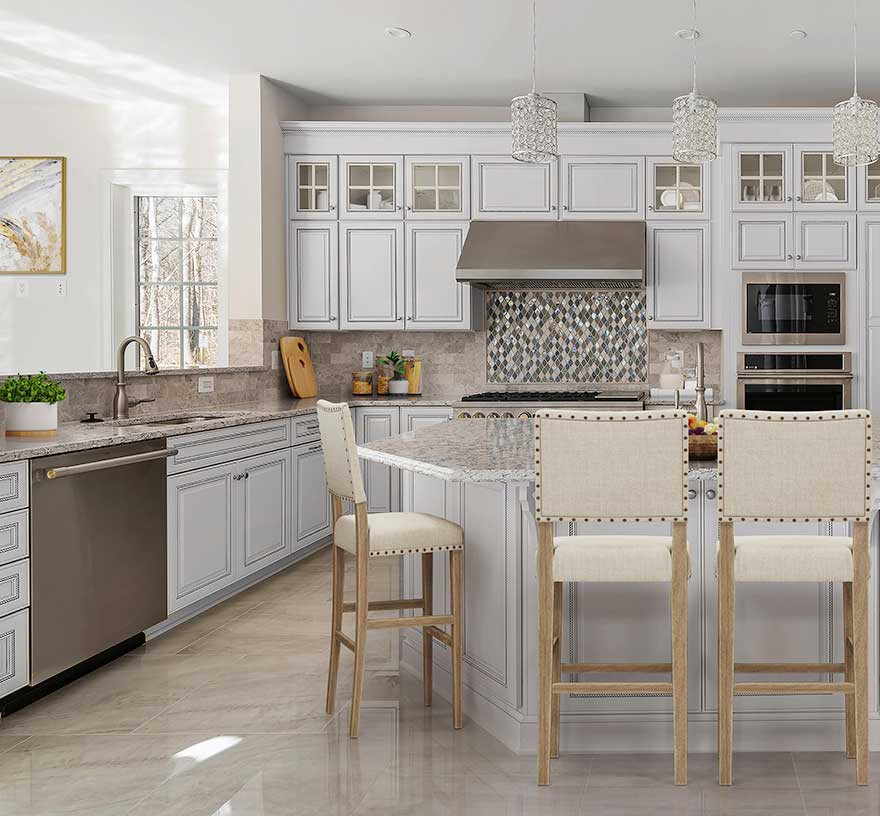 A kitchen with custom cabinets with glass insets, tile backsplash, and island with barstools in the foreground.