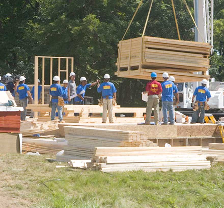 crews on the extreme makeover build move lumber by crane