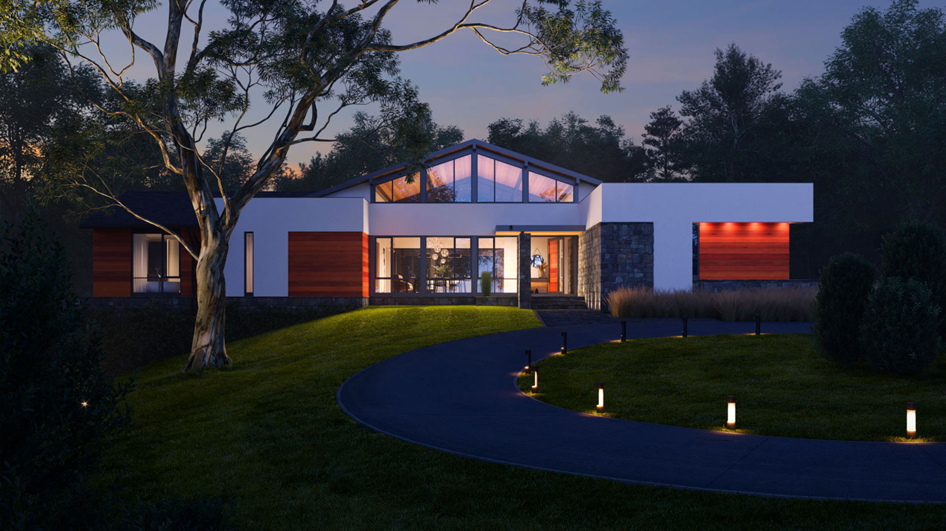An image of California Modern style custom home illuminated against the night sky, situated in a heavily wooded setting.