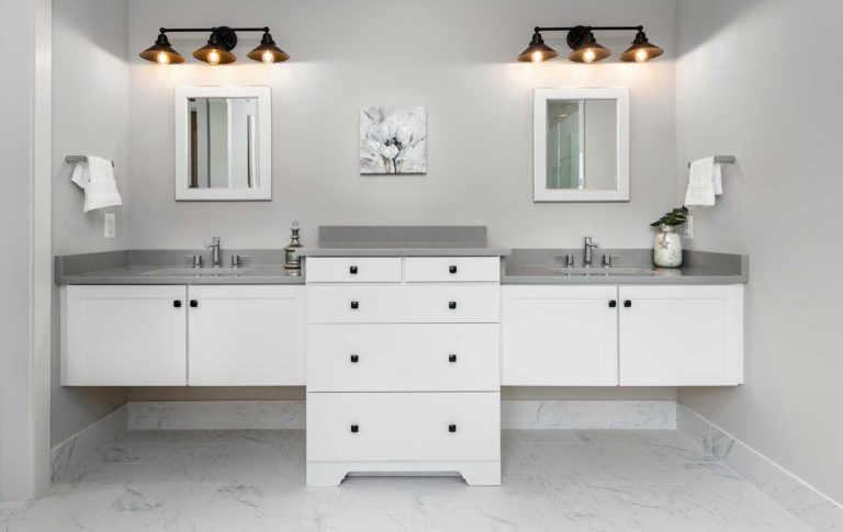 Modern double floating vanities in the modern farmhouse owners suite bath, white cabinets, grey tops