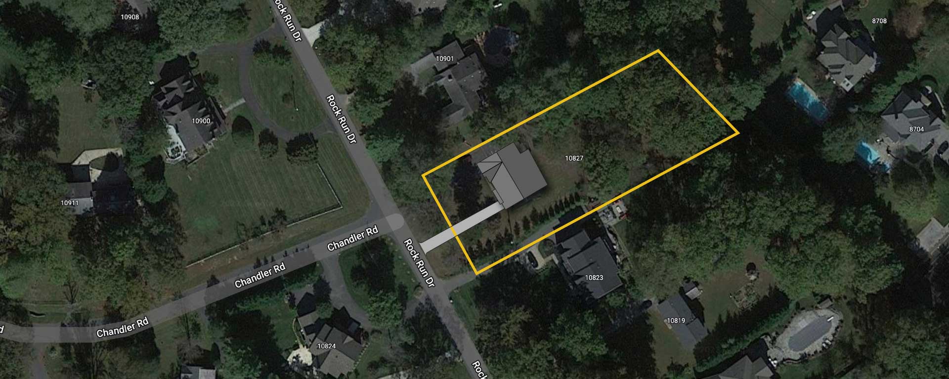 A satellite image showing the site outline of 10827 Rock Run Dr and proposed house placement.