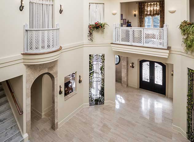 A two story space with romeo and juliet balcony, 2nd floor overlook, curved arch doorways