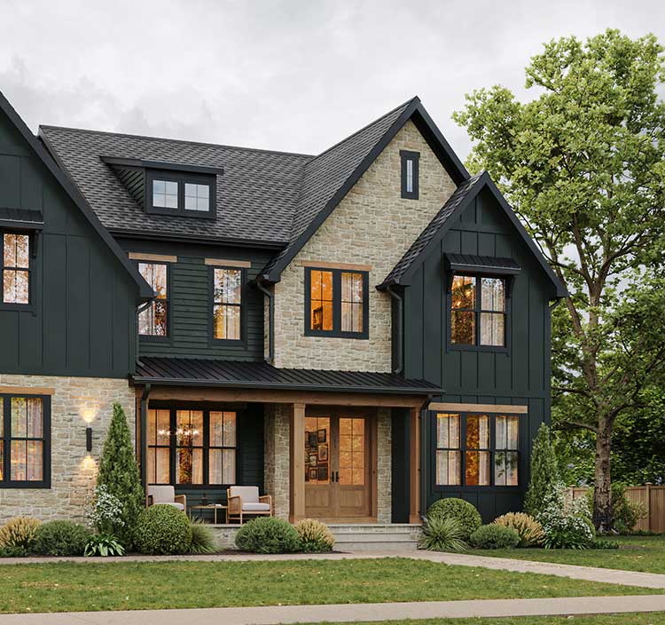 A modern farmhouse exterior in black board and batten and stone, with black windows and natural wood details.
