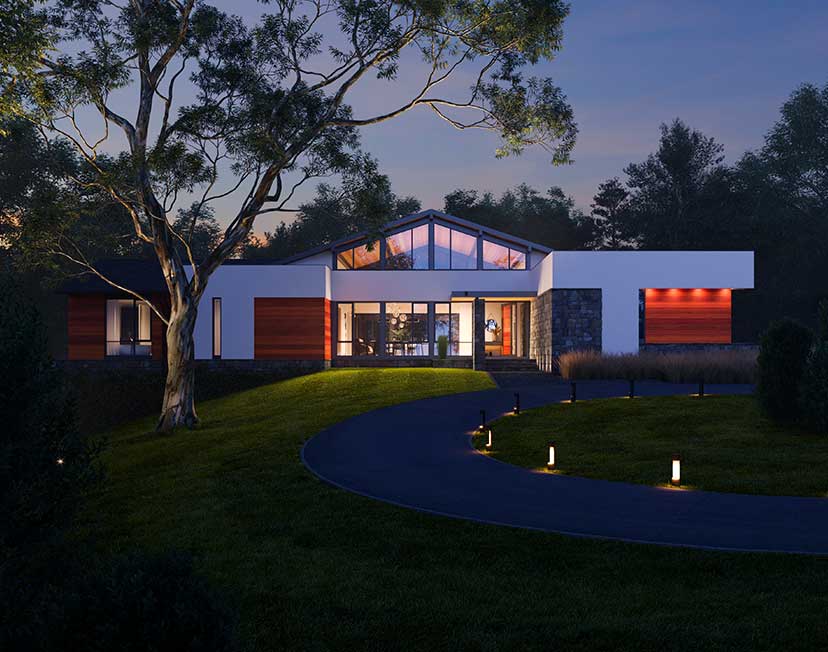 A nighttime image of a california modern style home illuminated from inside against a wooded background.