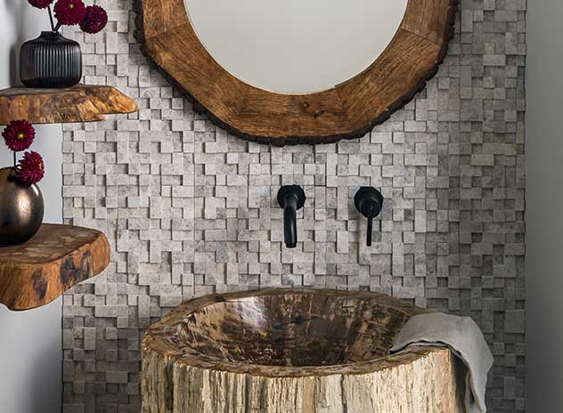 A Powder Room full of interesting textures and natural elements, including a log pedestal sink.