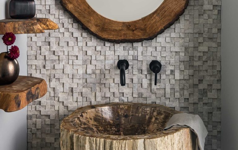A Powder Room full of interesting textures and natural elements, including a log pedestal sink.