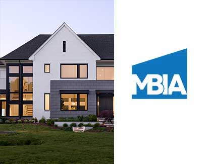 A contemporary home with large windows, exposed staircase, white brick and grey architectural block next to the MBIA logo.