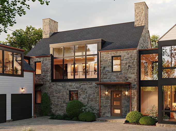 A custom home elevation in the contemporary cottage style, with natural elements of stone and copper mixed with modern design elements of large windows and block forms.