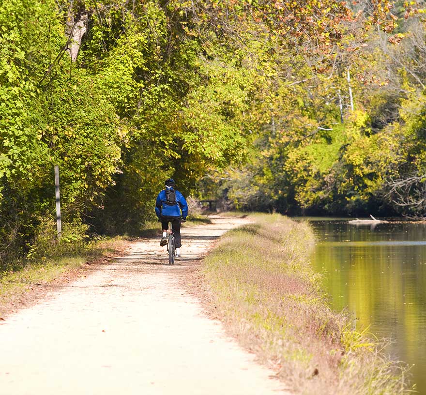 A biker rides along the Potomac River canal trail