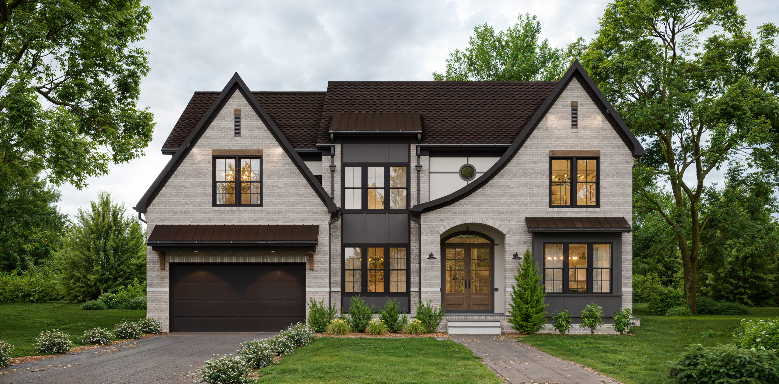 A front exterior design of a custom home in a modern tudor style