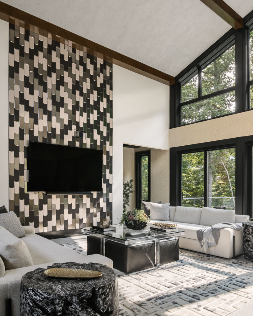 A floor-to-ceiling tile accent wall compliments the tall windows behind this Family Room.