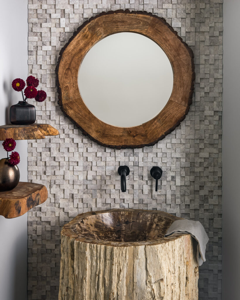 A Powder Room full of interesting textures and natural elements, including a log pedestal sink.