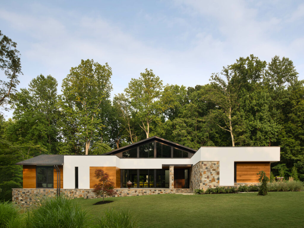 The front exterior, a California Modern inspired design, with natural materials of stone, wood and stucco.