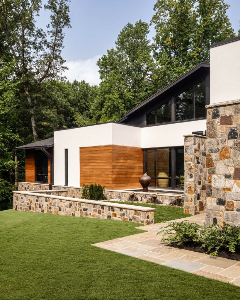 A complete view of the Zen Garden and Reflecting Pool approaching the front door, stone walls, fountain, reflecting pool and sculpture.