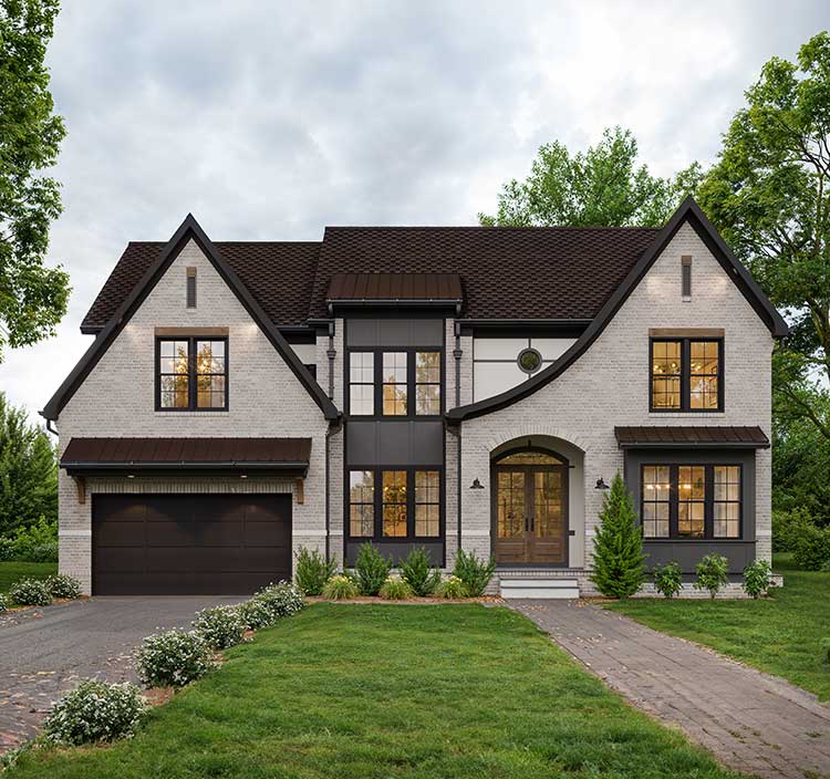 A front exterior design of a custom home in a modern tudor style