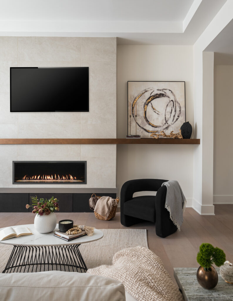 A Family Room with electronic fireplace with tile surround and stained mantle.