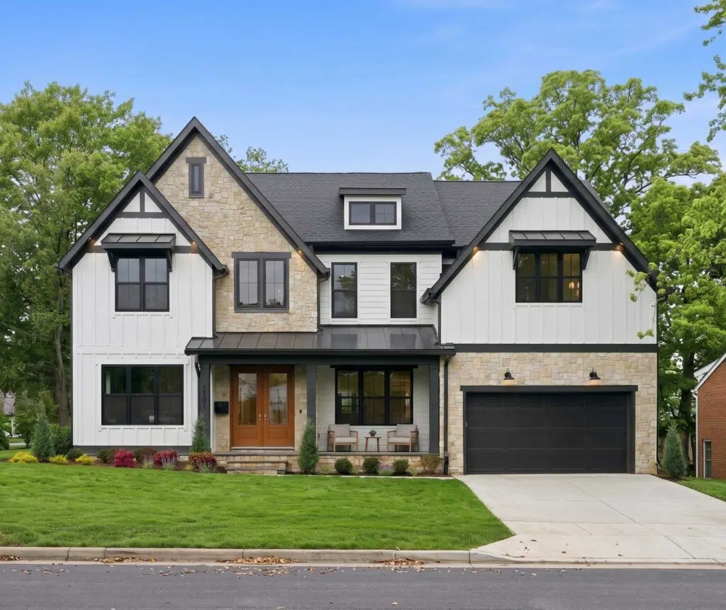 A modern two-story home with white board-and-batten siding, light stone accents, and black-trimmed windows.