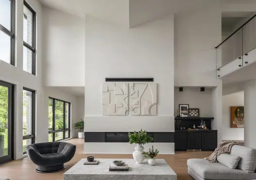 A two-story family room with a vaulted butterfly ceiling, liner fireplace, second story overlook and many large windows.